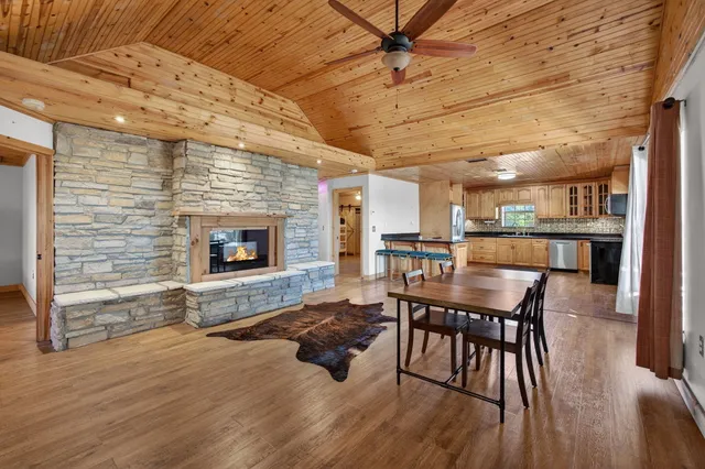 a living room with furniture wooden floor and a fireplace