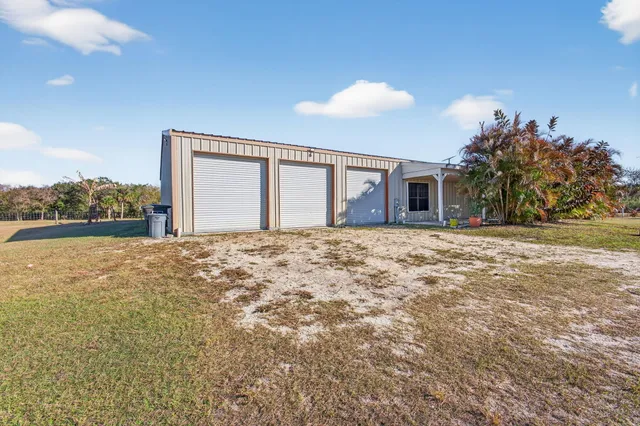 a view of a house with a yard and a patio