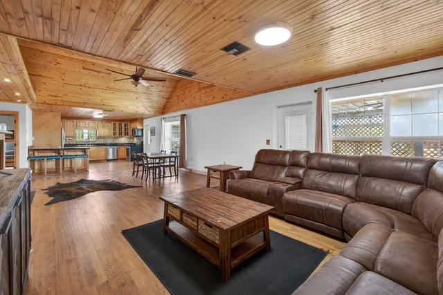 a living room with furniture and wooden floors