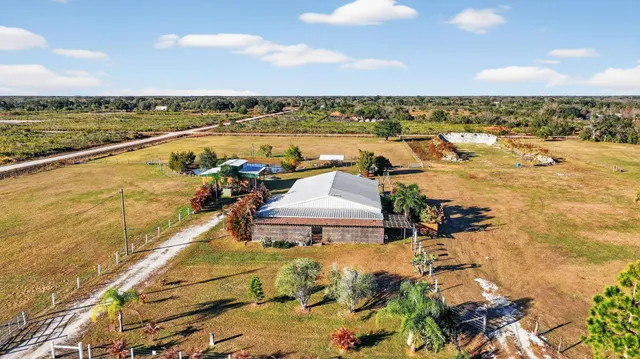 an aerial view of a house with a backyard