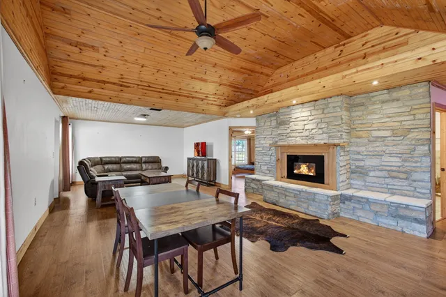 a dinning room with furniture and a fireplace