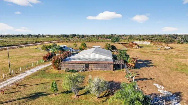 a view of a house with a yard and potted plants