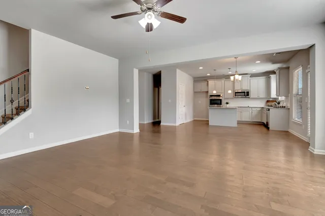 a view of a kitchen with a sink stainless steel appliances and cabinets