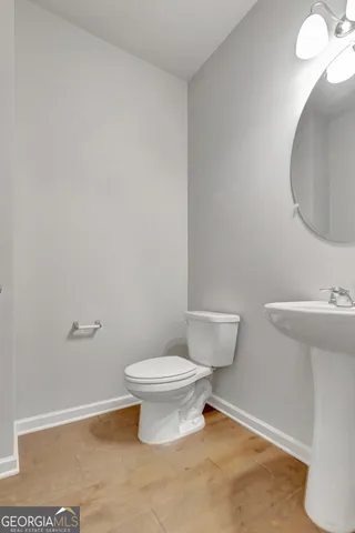 a white toilet sitting next to a bathroom sink