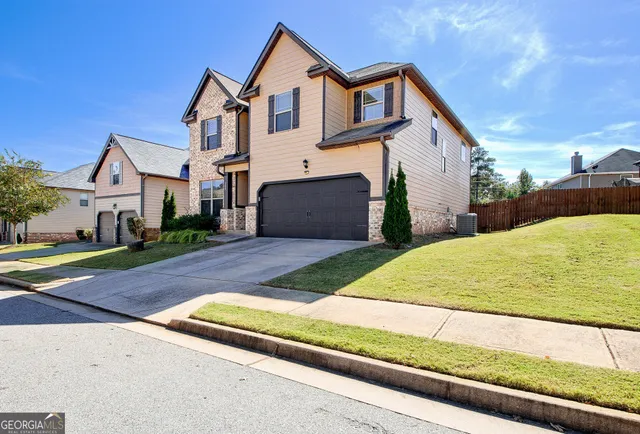a front view of a house with a yard and garage
