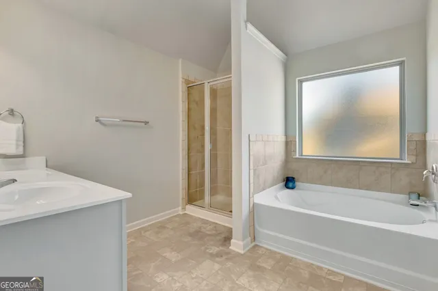 a bathroom with a double vanity sink and a mirror
