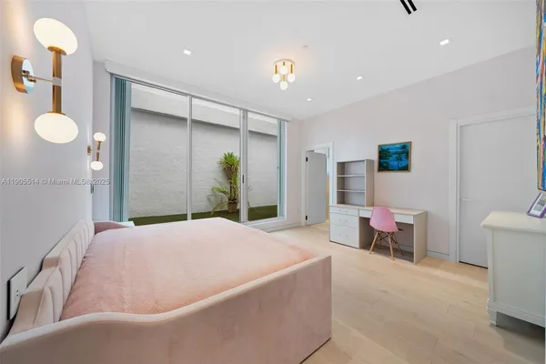 a living room with furniture a flat screen tv and a large window