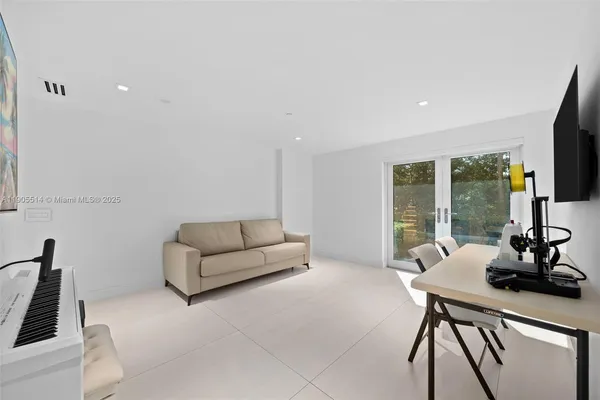 a view of a workspace with furniture and wooden floor