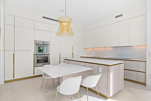 a kitchen with stainless steel appliances a stove a sink and a refrigerator