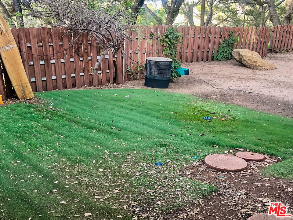 25614 Timpangos Drive Calabasas, CA 91302 - Photo 18 of 21 a view of a backyard with table and chairs potted plants and large tree