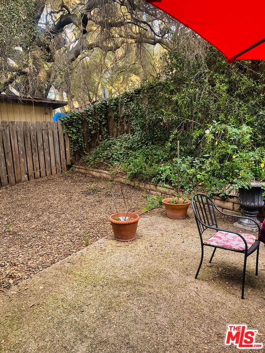 25614 Timpangos Drive Calabasas, CA 91302 - Photo 19 of 21 a backyard of a house with table and chairs