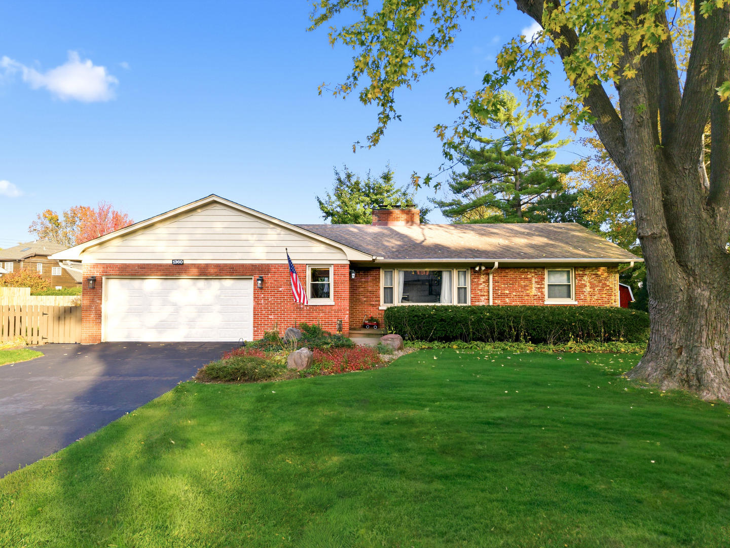 a front view of a house with a garden and yard