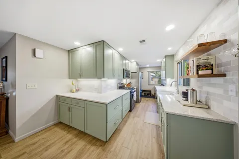 a spacious bathroom with a sink and a mirror