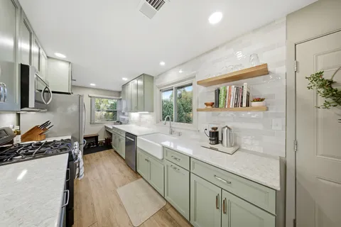 a kitchen with a sink stove and cabinets