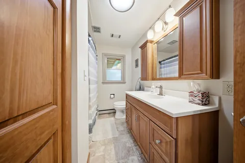 a bathroom with a sink a mirror and a toilet