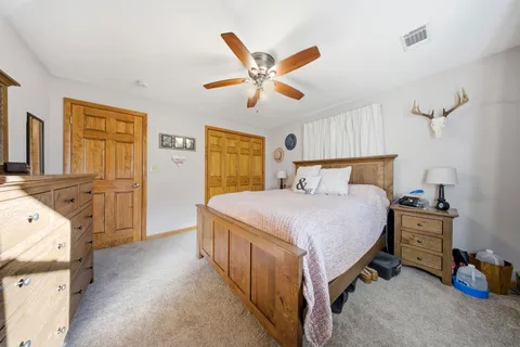 a bedroom with a bed and cabinets