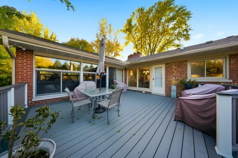 a view of a house with backyard sitting area and garden