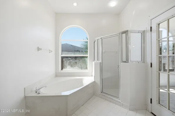 a bathroom with a bathtub and a shower