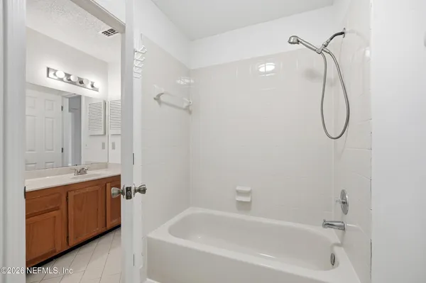 a bathroom with a granite countertop sink a toilet and shower