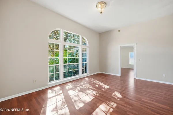 wooden floor in an empty room with a window