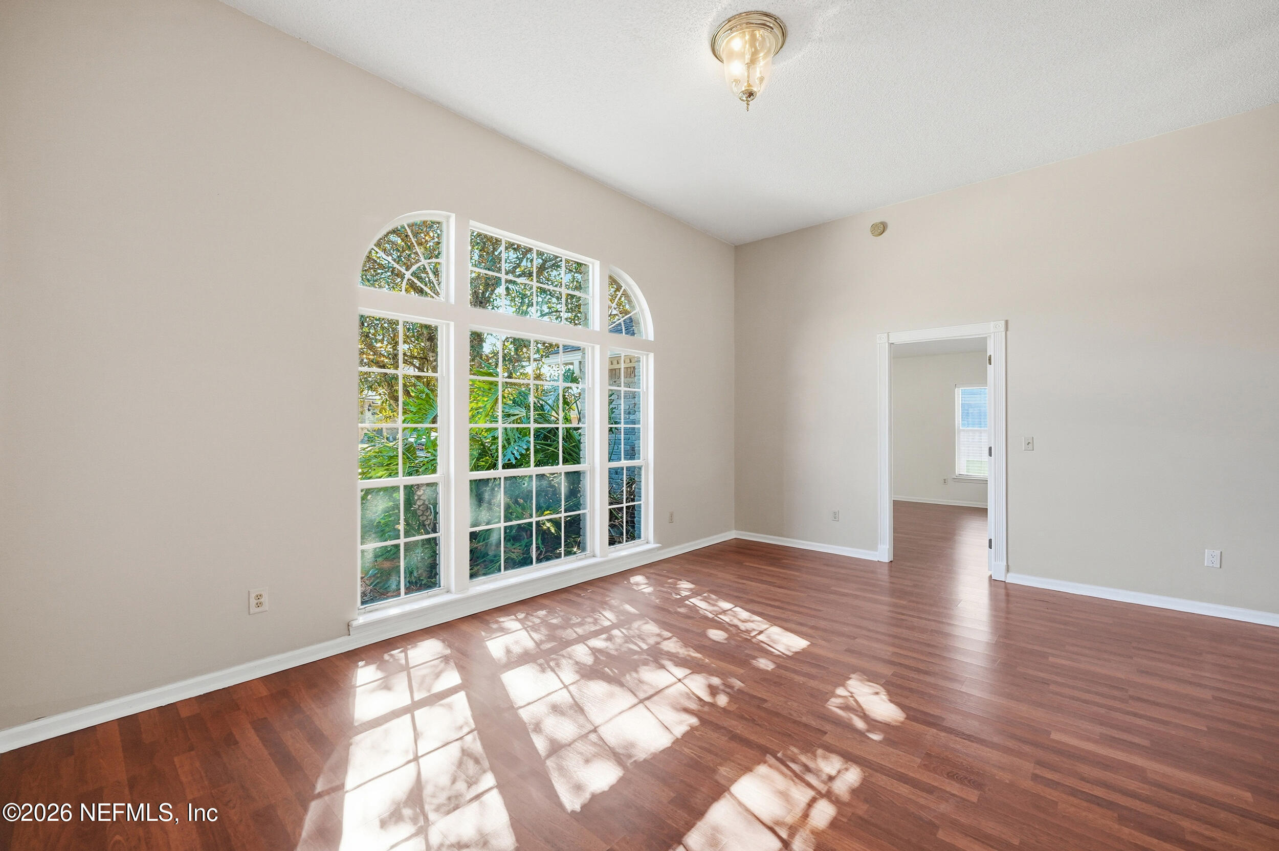 5019 Ripple Rush Drive North Jacksonville, FL 32257 - Photo 25 of 40 a view of an empty room with wooden floor and a window