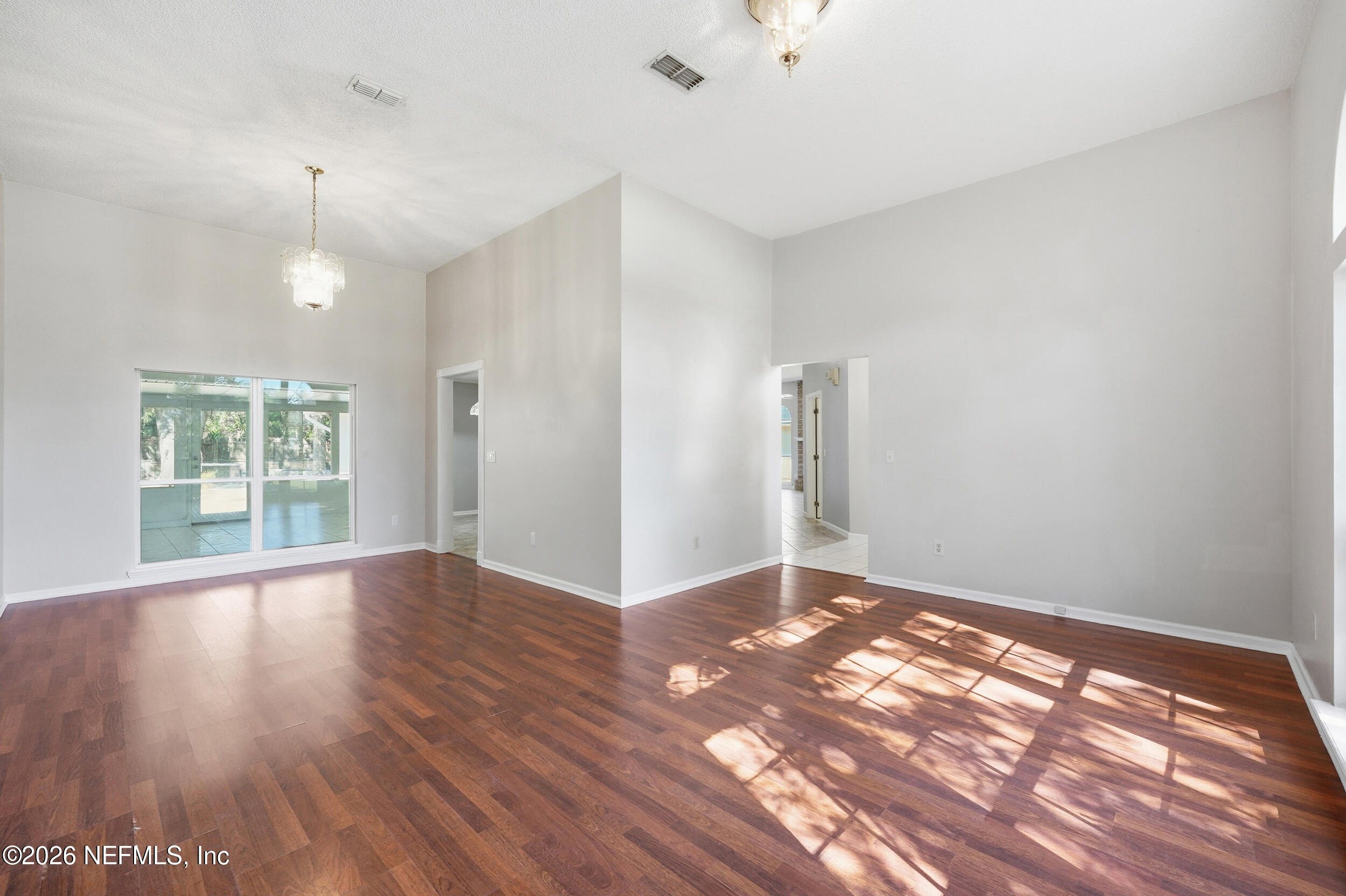 5019 Ripple Rush Drive North Jacksonville, FL 32257 - Photo 26 of 40 wooden floor in an empty room with a window