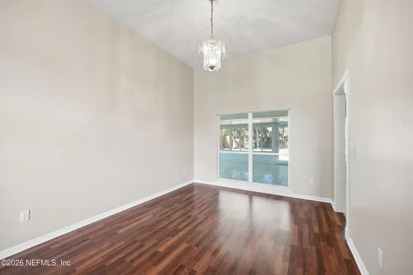 an empty room with fireplace and windows