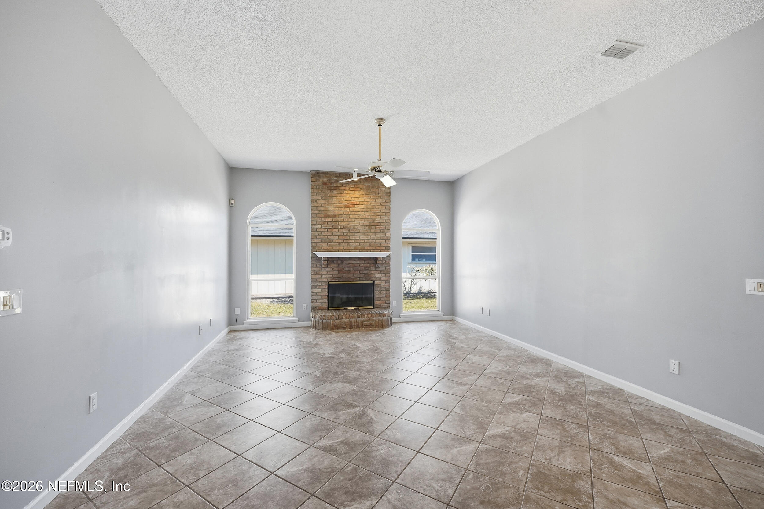5019 Ripple Rush Drive North Jacksonville, FL 32257 - Photo 28 of 40 an empty room with fireplace and windows