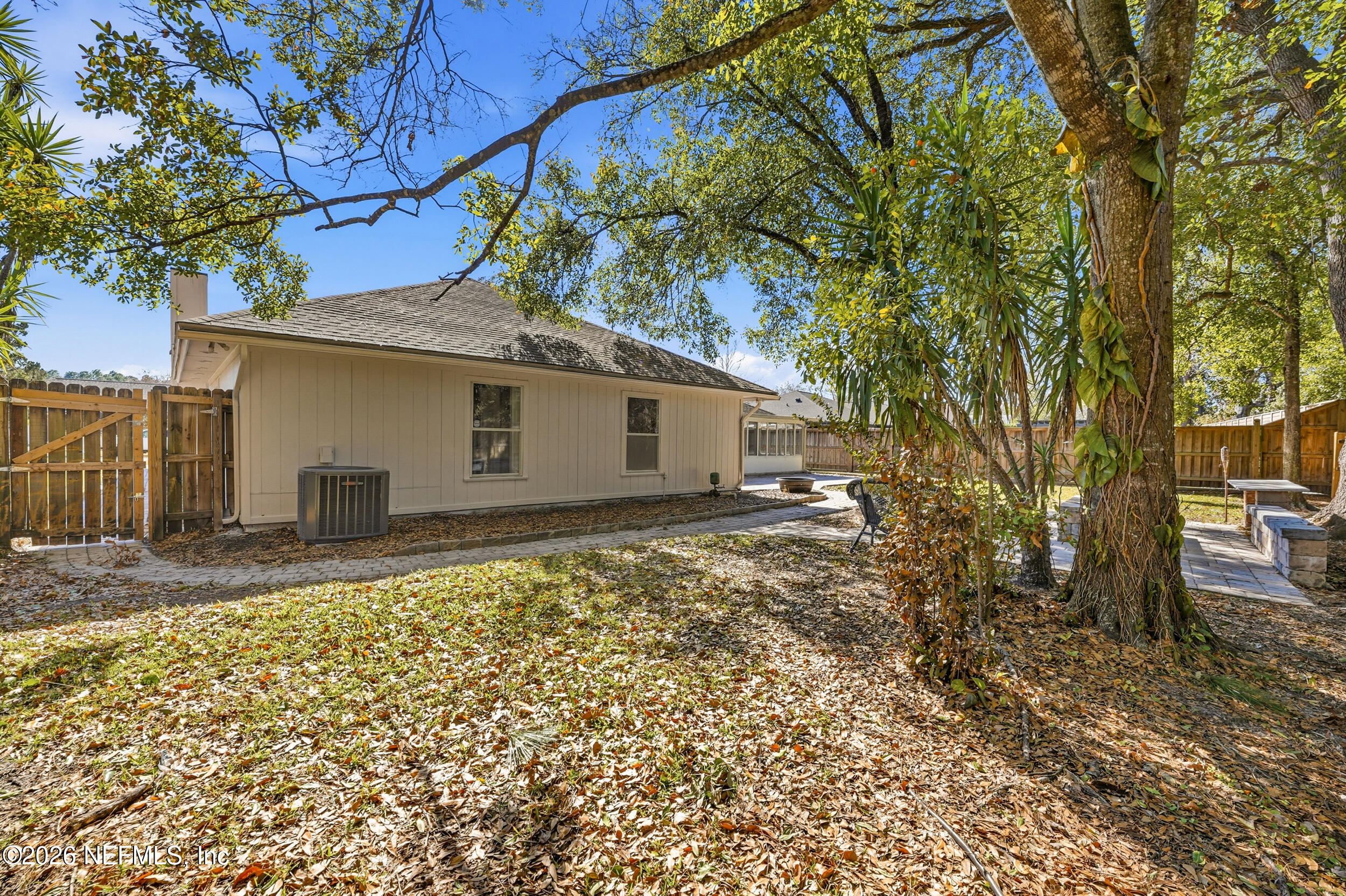 5019 Ripple Rush Drive North Jacksonville, FL 32257 - Photo 33 of 40 a backyard of a house with large trees and outdoor seating