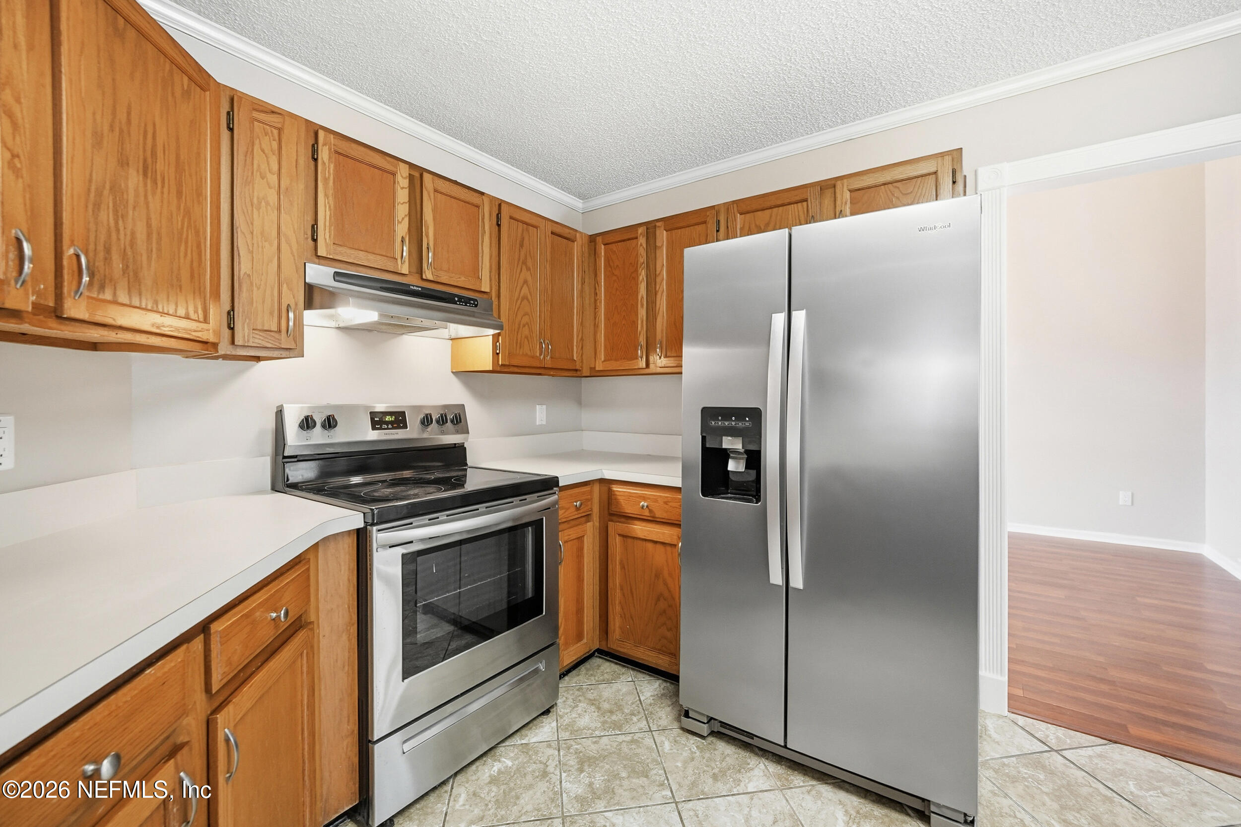 5019 Ripple Rush Drive North Jacksonville, FL 32257 - Photo 4 of 40 a kitchen with a refrigerator sink and cabinets