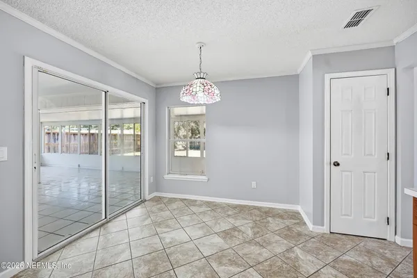 a view of an empty room with glass door