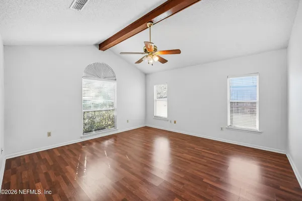 wooden floor in an empty room with a window