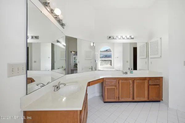 a large bathroom with a double vanity sink mirror and double
