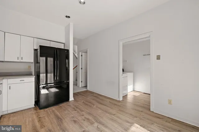 a kitchen with a refrigerator and a stove top oven