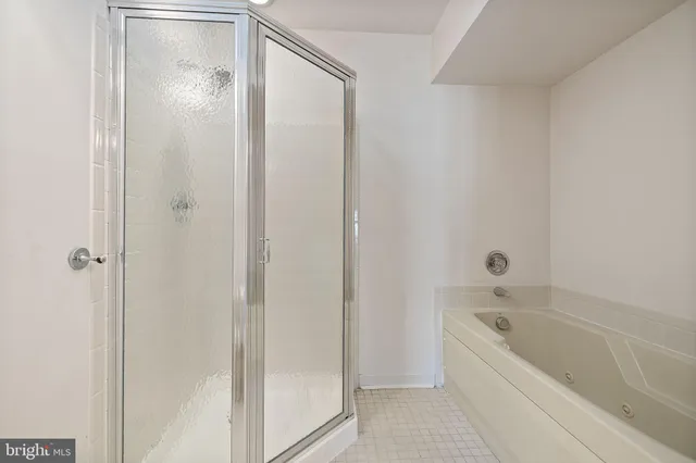 a bathroom with a bathtub and a shower