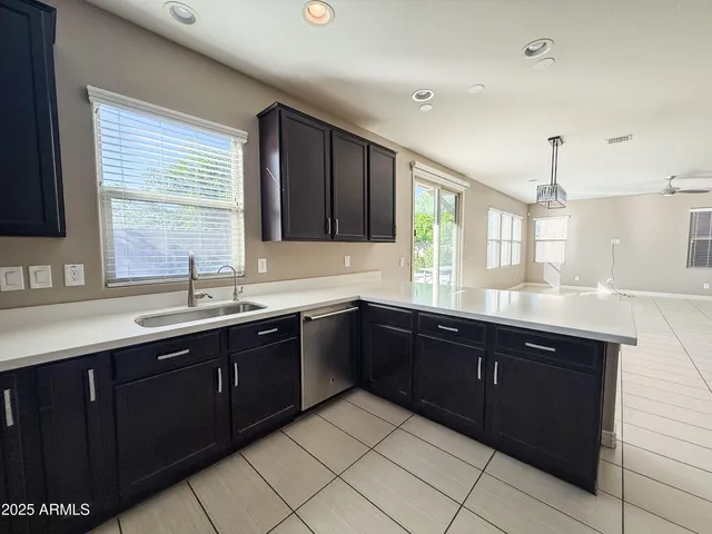a kitchen with a sink and wooden cabinets