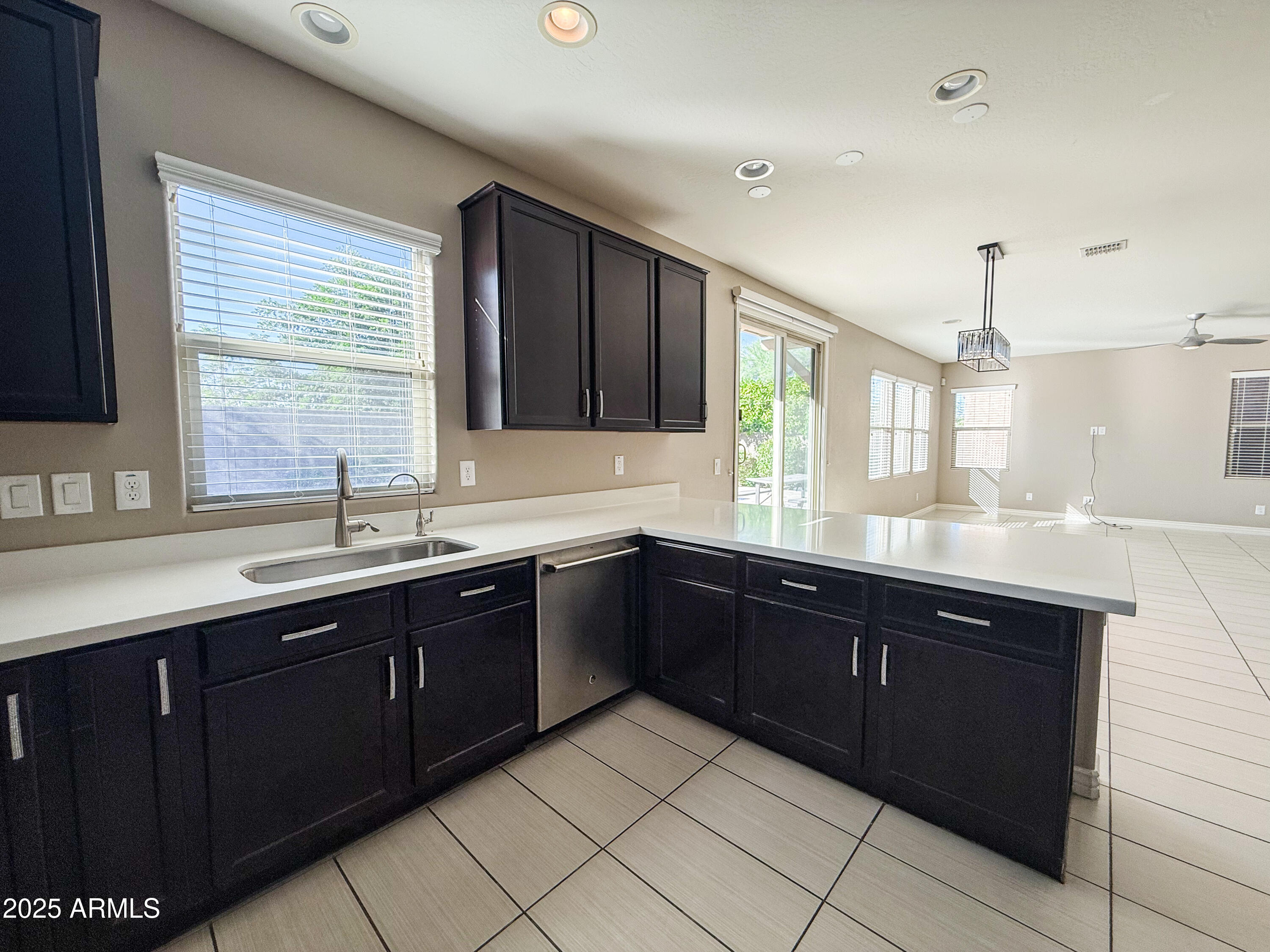 4711 East Daley Lane Phoenix, AZ 85050 - Photo 12 of 43 a kitchen with a sink and wooden cabinets