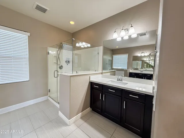 a spacious bathroom with a double vanity sink and a mirror