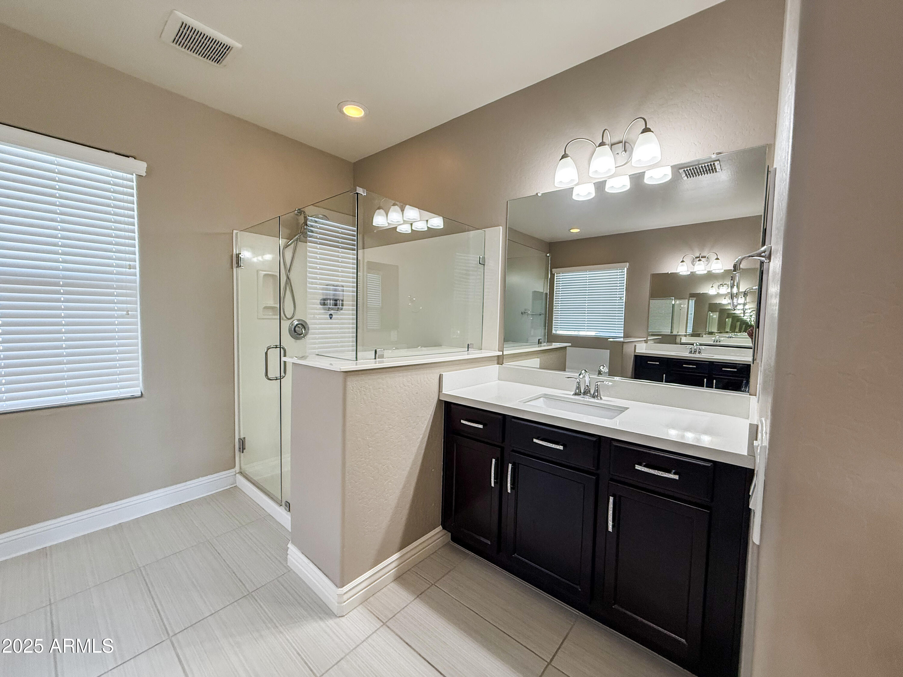 4711 East Daley Lane Phoenix, AZ 85050 - Photo 29 of 43 a spacious bathroom with a double vanity sink and a mirror
