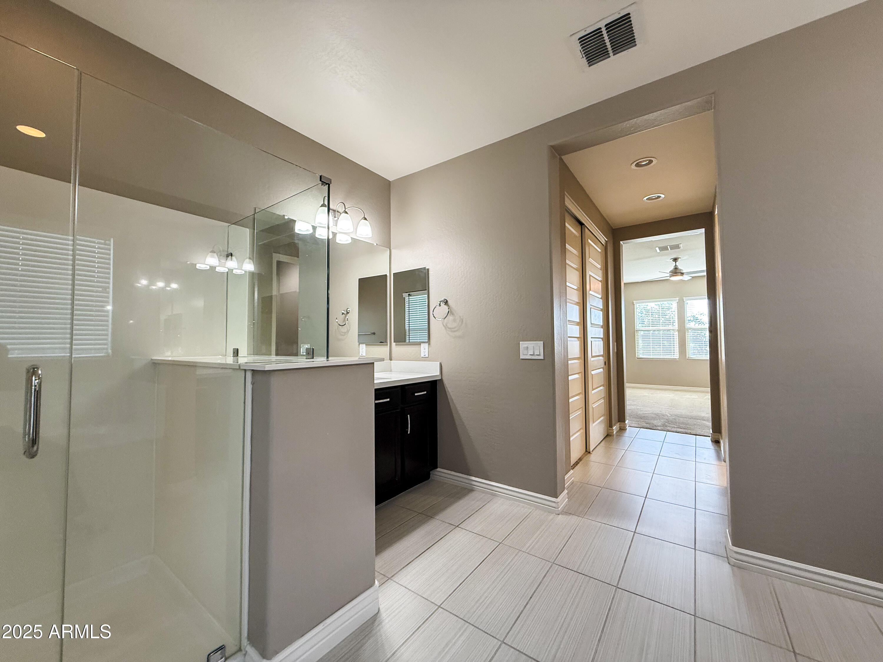 4711 East Daley Lane Phoenix, AZ 85050 - Photo 32 of 43 a bathroom with a glass shower door and a sink