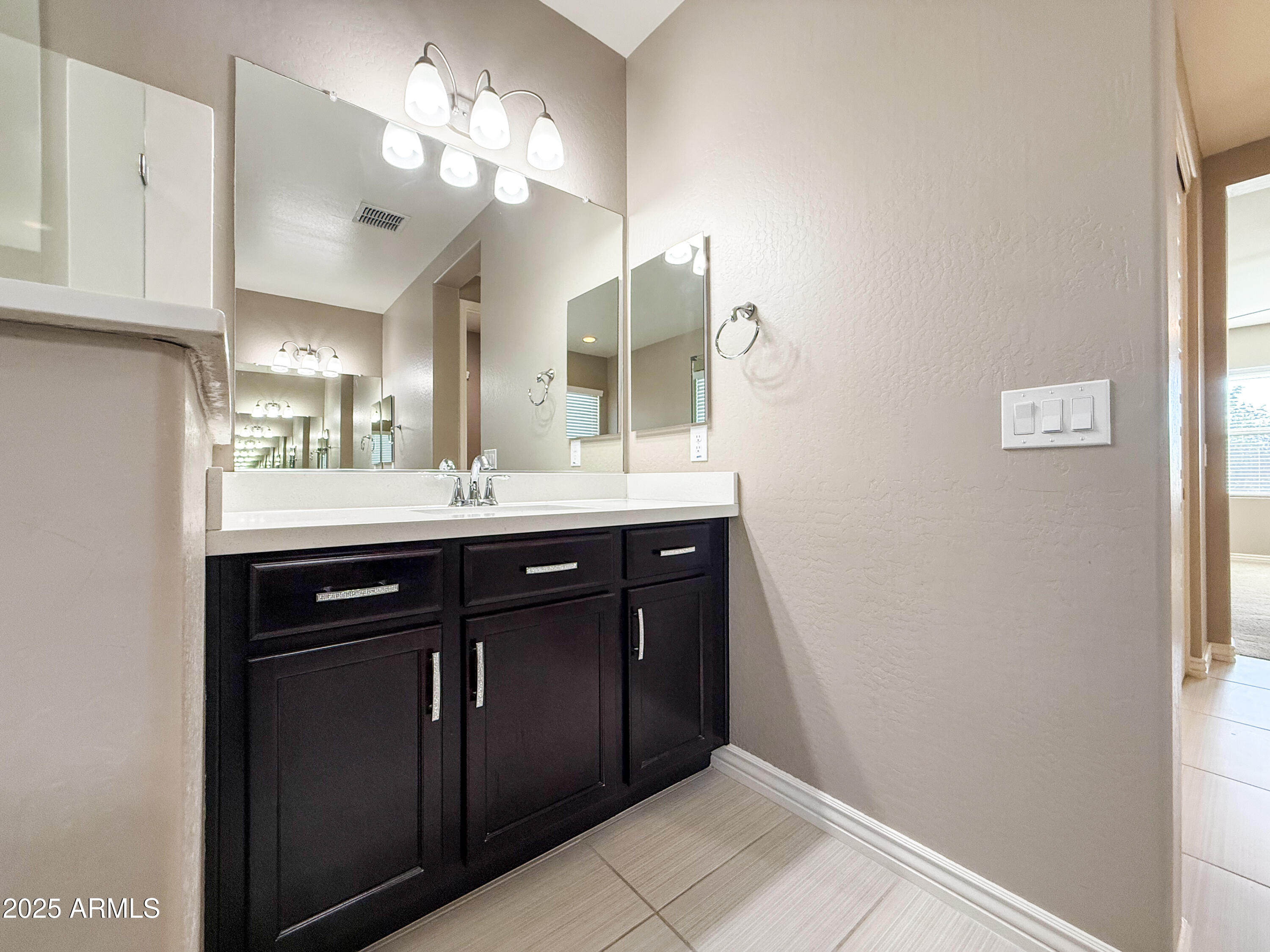 4711 East Daley Lane Phoenix, AZ 85050 - Photo 33 of 43 a bathroom with a sink and a mirror