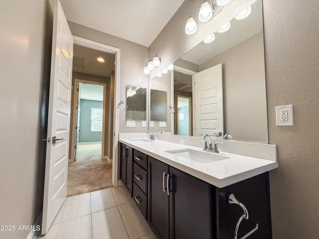 a bathroom with a sink double vanity and a mirror