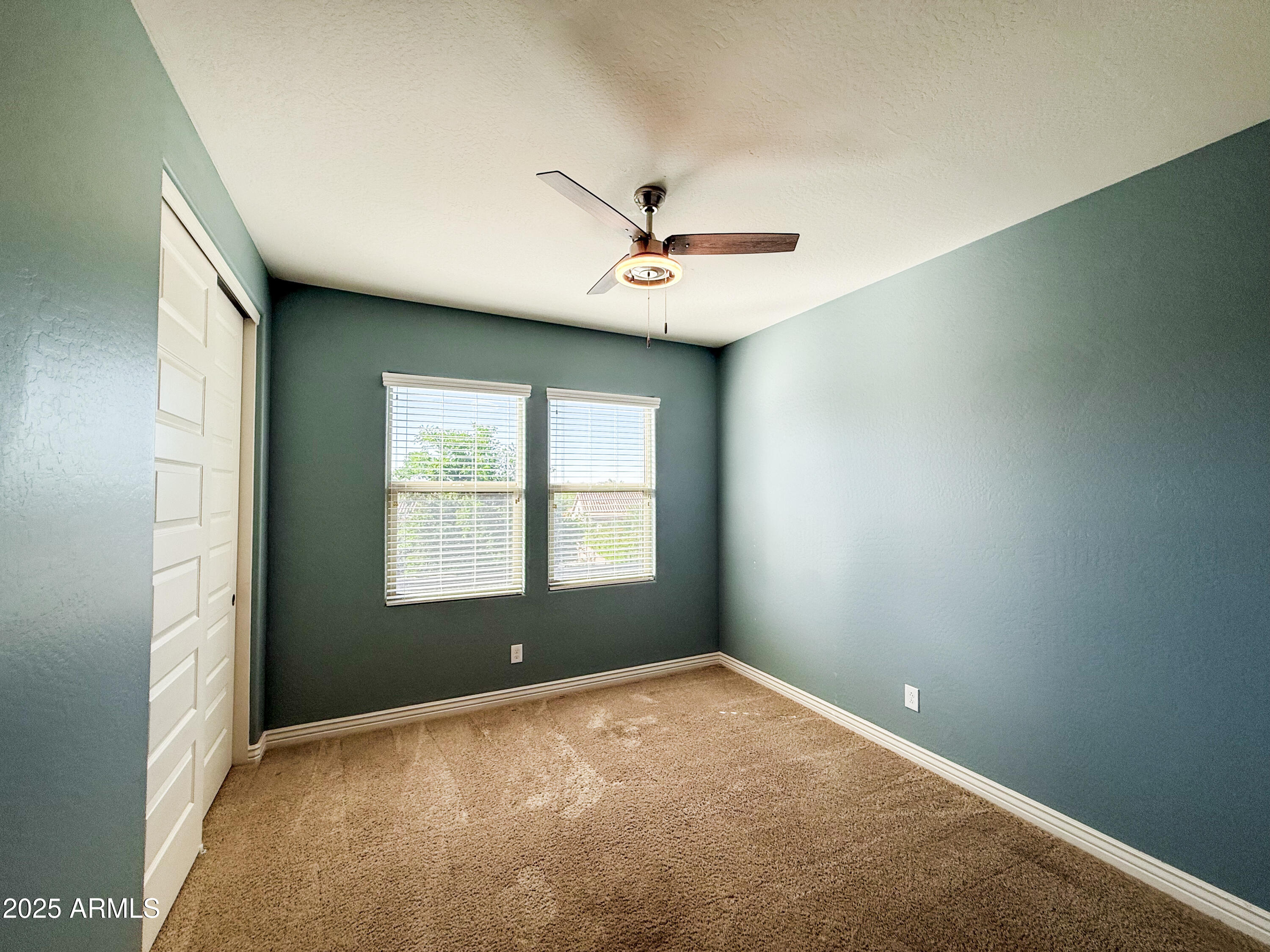 4711 East Daley Lane Phoenix, AZ 85050 - Photo 39 of 43 an empty room with a window and a ceiling fan