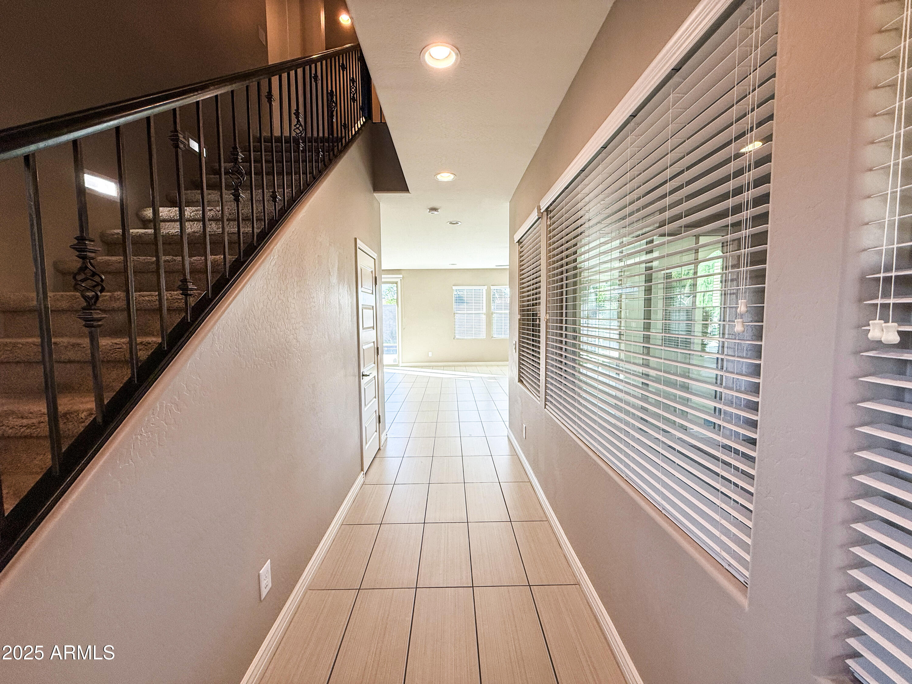 4711 East Daley Lane Phoenix, AZ 85050 - Photo 4 of 43 a view of a hallway with wooden floor and staircase