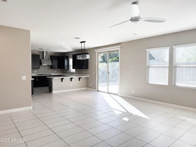 a large white kitchen with a stove a sink and a microwave