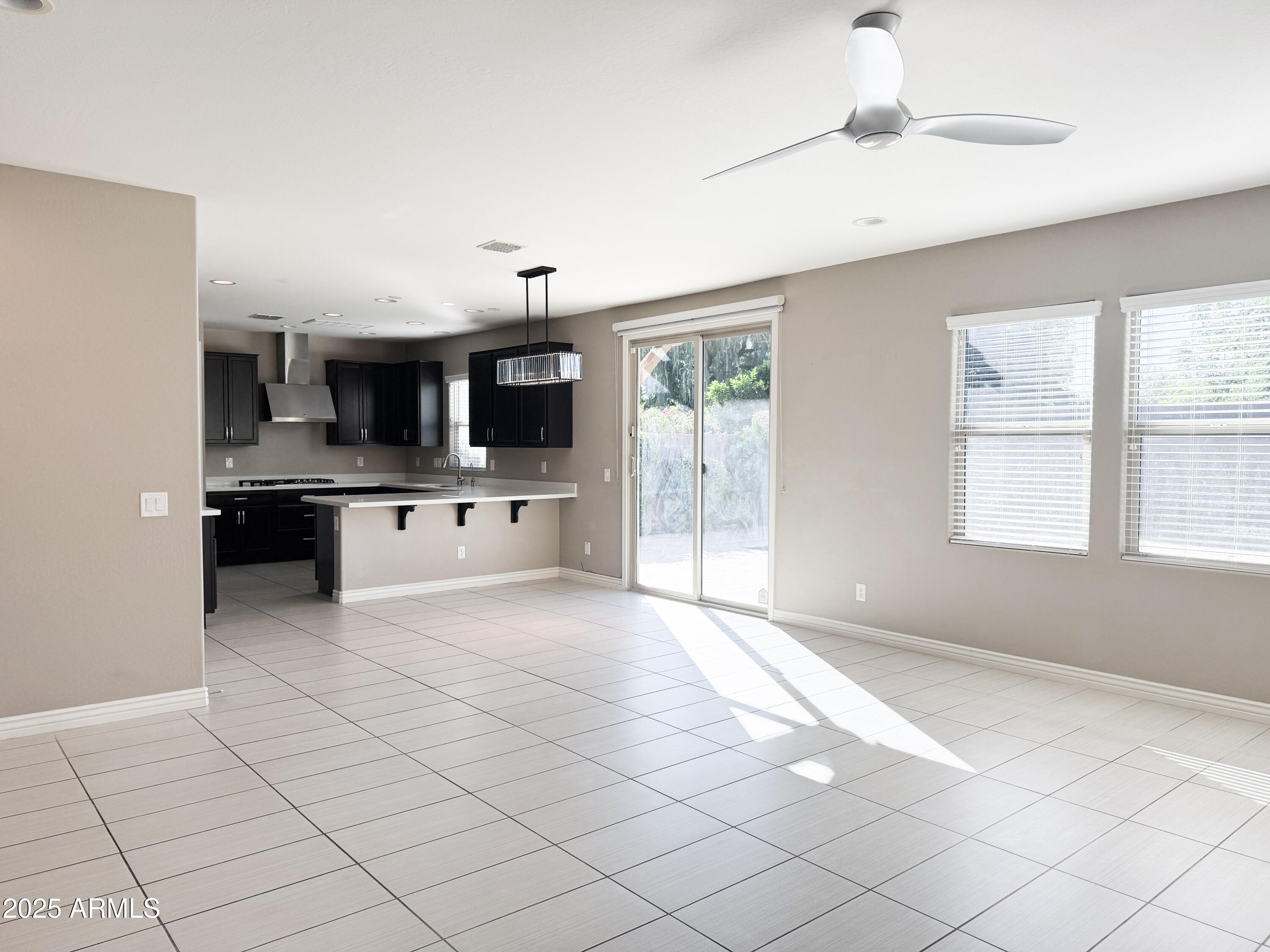 4711 East Daley Lane Phoenix, AZ 85050 - Photo 6 of 43 a large white kitchen with a stove a sink and a microwave