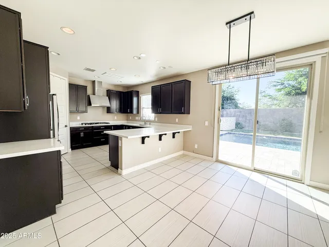 a kitchen with stainless steel appliances granite countertop a stove top oven a sink a counter top space and cabinets