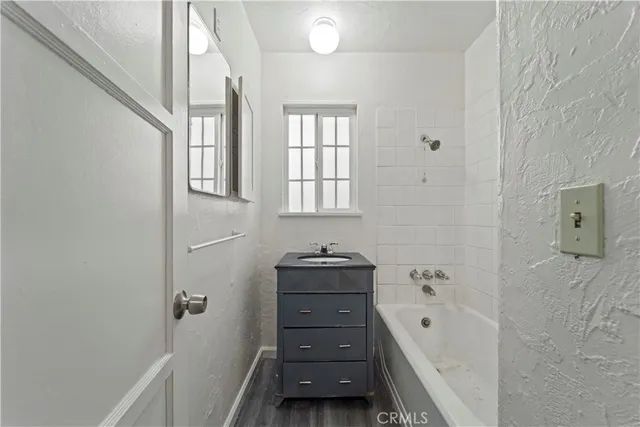 a bathroom with a bathtub sink and a window