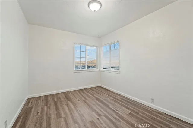 a view of a room with wooden floor and window