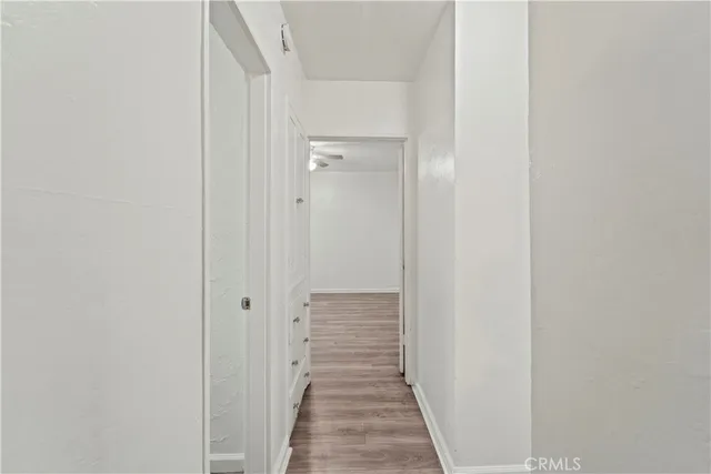 a view of a hallway with wooden floor